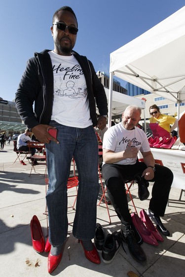 Keith Francis (left) and Boris Zvokovic of the Legislative Assembly of Alberta's Heeling Fine team try on their shoes during YWCA Edmonton's Walk A Mile In Her Shoes  in Edmonton, Alberta on Wednesday, September 21, 2016. Over $200,000 was raised for YWCA violence prevention and recovery programs.