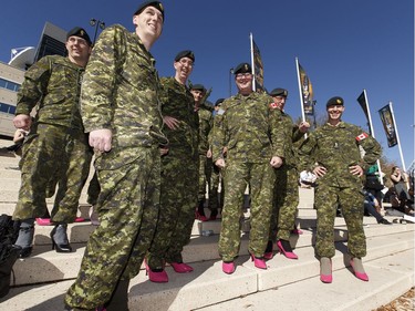 Members of 3rd Canadian Division Support Group, lead by Colonel S.M. Lacroix (centre), show their shoes in support of YWCA Edmonton's Walk A Mile In Her Shoes in Edmonton, Alberta on Wednesday, September 21, 2016. Over $200,000 was raised for YWCA violence prevention and recovery programs.