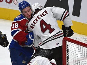 Edmonton Oil Kings forward Kobe Mohr, right, and Red Deer Rebels Alexander Alexeyev battle in front of goalie Trevor Martin in WHL action at Rogers Place, the first-ever hockey game in the new arena in Edmonton Saturday, September 24, 2016. The Oil Kings play their second game at Rogers Place on Friday against the Kelowna Rockets.