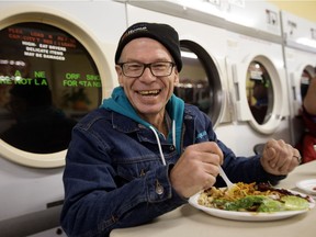 Kenneth McGillicky enjoys the annual community Thanksgiving dinner at the Millbourne Laundromat, 109 Millbourne Road East, in Edmonton on Monday Oct. 10, 2016.