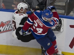 Edmonton Oil Kings Aaron Irving takes Moose Jaw Warriors Tristin Langan into the boards during second period WHL action on Monday, October 17, 2016 in Edmonton. The Oil Kings host the Prince Albert Raiders at Rogers Place on Friday.