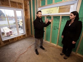 UrbanAge Homes Richard Nault  gives Municipal Affairs Minister Danielle Larivee a tour of a "skinny" home construction site, 13310 - 106A Ave., in Edmonton on Tuesday, Oct. 25, 2016. The Government of Alberta has updated or adopted seven new building codes to help the province be more energy efficient and reduce greenhouse gas emissions.
