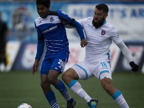 Shamit Shome of FC Edmonton and Miami FC Rhett Bernstein fight for the ball during North American Soccer League action at Clarke Field on Sunday, September 11, 2016 in Edmonton. FC Edmonton conclude their NASL regular season schedule in Miami on Friday.