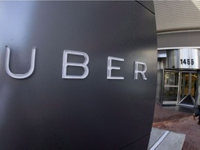 A man leaves the headquarters of Uber in San Francisco on Dec. 16, 2014.
