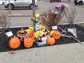 A memorial has sprung up at the site of a fiery collision that killed a woman during the afternoon commute Monday, Oct. 24, 2016.