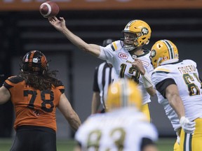 BC Lions defensive lineman David Menard (78) watches as Edmonton Eskimos quarterback Mike Reilly (13) makes a throw during the second half of CFL football action, in Vancouver on Saturday, Oct. 22, 2016.