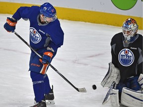 Benoit Pouliot deflects the puck in front of goalie Cam Talbot during Oilers practice, a cancelled day off after a poor performance Sunday night against Buffalo at Rogers Place in Edmonton, Monday, October 17, 2016.