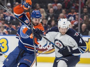 Benoit Pouliot (67)of the Edmonton Oilers, is tied up by Paul Postma of the Winnipeg Jets at Rogers Place in Edmonton on October 5, 2016. Photo by Shaughn Butts / Postmedia Jim Matheson Story Photos off Oilers game for multiple writers copy in Oct. 7 editions.