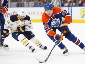 Jesse Puljujarvi (98) of the Edmonton Oilers is pursued by Brian Gionta of the Buffalo Sabres on October 16, 2016 at Rogers Place.