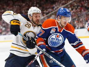 Oscar Klefbom (77) of the Edmonton Oilers defends the zone against Zemgus Girgensons of the Buffalo Sabres on October 16, 2016 at Rogers Place in Edmonton.
