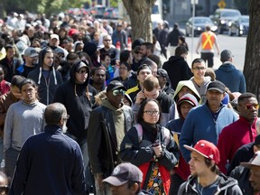 Fort McMurray wildfire evacuees line up outside the Universiade Pavilion (Butterdome) for relief funding at the University of Alberta, in Edmonton Alta. on Thursday May 12, 2016.