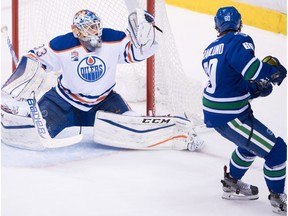 Edmonton Oilers' goalie Cam Talbot, left, stops Vancouver Canucks' Markus Granlund, of Finland, during the second period of an NHL hockey game in Vancouver, B.C., on Friday October 28, 2016.