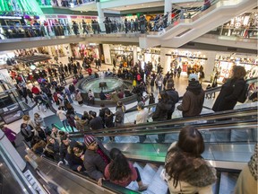 Retail experts predict Canadian Christmas shoppers like these people in Toronto's Eaton Centre will open their wallets wider this holiday season, even in economically hard-hit Alberta.