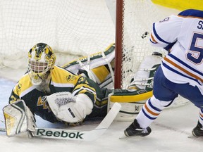 Edmonton Oilers' Cole Sanford (59) scores a goal on University of Alberta Golden Bears goalie Luke Siemens (30) during third period exhibition hockey action as the Oilers rookies take on the university team in Edmonton, Alta., on Wednesday September 16, 2015.