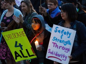 Protesters gather during the Take Back the Night rally at Sir Winston Churchill Square in Edmonton on Friday, Oct. 21, 2016.