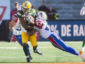 Edmonton Eskimos' Troy Stoudermire, left, is tackled by Montreal Alouettes' Dominique Termansen during second half CFL football action against the Montreal Alouettes in Montreal, Monday, October 10, 2016.