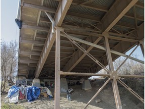 A homeless man walks up to a camp underneath Jasper Avenue near 92 Street in 2015.