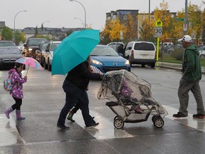 Traffic waits for pedestrians in the vicinity of the school zone near Dr. Donald Massey Elementary-Junior High School in Edmonton in a 2015 file photo.