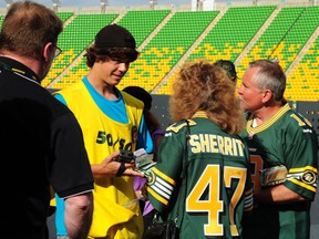 Kolton Batdorf was busy selling 50 50 tickets for the big draw at the Edmonton Eskimos-Calgary Stampeders CFL football game at Commonwealth Stadium in Edmonton, July 24, 2014.