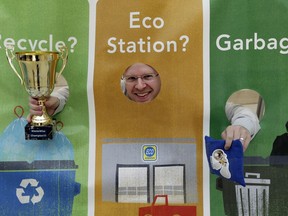 Edmonton blogger Mack Male celebrates his victory at a waste-sorting competition bean bag toss held at Edmonton City Hall on Wednesday October 26, 2016. He was joined by Edmonton Oiler Andrew Ference, Edmonton city Coun. Andrew Knack and kids from City Hall School, where the City of Edmonton officially launched its new WasteWise app.