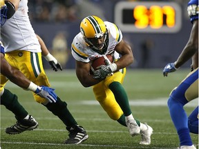 Edmonton Eskimos RB John White lowers his shoulder in the hole during CFL action against the Winnipeg Blue Bombers in Winnipeg on Fri., Sept. 30, 2016.