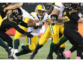 Edmonton Eskimos running back John White (30) runs for some yards during the second-half of CFL football action against the Hamilton Tiger-Cats in Hamilton on Friday, October 28, 2016.