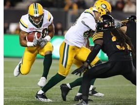 Edmonton Eskimos running back John White (30) runs for some yards during the first-half of CFL football action against the Hamilton Tiger-Cats in Hamilton on Friday, October 28, 2016.