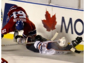 Edmonton-November 22, 2003-Smyth takes a hit from Canadiens #51 Bouillon during the Heritage Classic at Commonwealth Stadium Saturday.