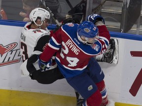Edmonton Oil Kings Aaron Irving takes Moose Jaw Warriors Tristin Langan into the boards during second period WHL action on Monday, October 17, 2016 in Edmonton.
