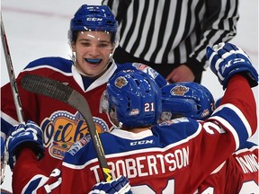 Edmonton Oil Kings teammates celebrate Tyler Robertson's goal on Red Deer Rebels goalie Trevor Martin (35) in WHL action at Rogers Place, the first-ever hockey game in the new arena in Edmonton Saturday, September 24, 2016.