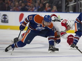 Edmonton Oilers Anton Lander (51) slows down Carolina Hurricanes Jaccob Slavin (74) during second period NHL action on Tuesday, October 18, 2016 in Edmonton. Greg Southam / Postmedia