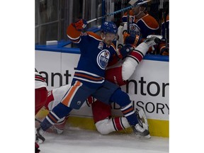 Edmonton Oilers Anton Lander (51) upends Carolina Hurricanes Jakub Nakladal (14) during first period NHL action on Tuesday, October 18, 2016 in Edmonton.