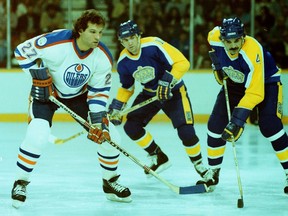 From left, Edmonton Oilers forward Dave Semenko lines up against Los Angeles Kings forward Dave Taylor and defenceman Jerry Korab in NHL action  at Northlands Coliseum during the 1982-83 season.