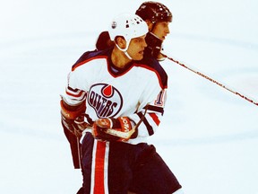 Edmonton Oilers forward shadows former teammate and Los Angeles Kings star Wayne Gretzky in a 1990 games.