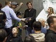 Edmonton Oilers great Wayne Gretzky (centre) signs autographs of his book at a book signing at West Edmonton Mall in Edmonton on Monday, Oct. 24, 2016.