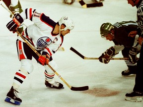 Edmonton Oilers captain Mark Messier takes a faceoff against Hartford Whalers centre Dean Evason in 1990.