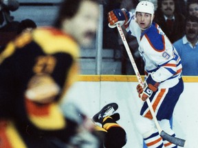Edmonton Oilers centre Wayne Gretzky, right, in action against the visiting Vancouver Canucks in an undated photo.