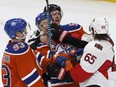 Edmonton's Anton Lander (51) is face washed by Ottawa's Erik Karlsson (65) during the third period of a NHL game between the Edmonton Oilers and the Ottawa Senators at Rogers Place in Edmonton, Alberta on Sunday, October 30, 2016. Ian Kucerak / Postmedia Photos off Oilers game for multiple writers copy in Oct. 31 editions.