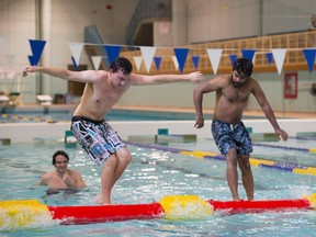 From left, Joey Dachwitz and Jabed Hossain duel for last man standing. Campus Recreation Services at NAIT held a log rolling competition in their pool on October 20, 2016.