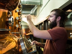 Wood Buffalo Brewing Co. head brewer Spike Baker is turning 1,000 kilograms of malt left on the side patio of the Morrison Street brewpub, where it absorbed smoke from this past summer's forest fire, into a signature whisky.