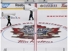 Workers put the finishing touches to the NHL's Heritage Classic outdoor rink in Winnipeg on Thursday, October 13, 2016. Winnipeg will host games between current and alumni players from the Winnipeg Jets and Edmonton Oilers this weekend.