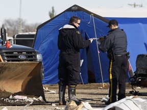 Investigators look for evidence at the scene of a fatal fire at the Bashaw Motor Inn in Bashaw on Oct. 11, 2016. The fire broke out on Oct. 9.