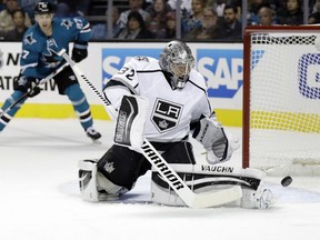 Los Angeles Kings goalie Jonathan Quick deflects a shot on goal against the San Jose Sharks during the first period of an NHL hockey game Oct. 12, 2016, in San Jose, Calif.