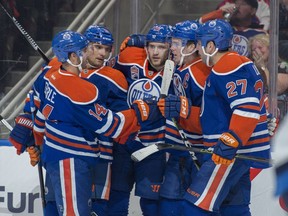 Jordan Eberle (14), Andrej Sekera (2), Leon Draisaitl (29) and Milan Lucic (27) of the Edmonton Oilers, celebrate a first period goal by Connor McDavid (97) against the Winnipeg Jets at Rogers Place in Edmonton on October 5, 2016.