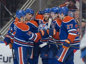 Will the start of the regular NHL season bring reason for Oilers fans to celebrate like in this pre-season moment? Jordan Eberle (14), Andrej Sekera (2), Leon Draisaitl (29) and Milan Lucic (27) of the Edmonton Oilers, celebrate a first period goal by Connor McDavid (97) against the Winnipeg Jets at Rogers Place on Oct. 5, 2016.