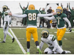 Kicker Brent Arthur and Adam Zajdel of the Alberta Golden Bears, celebrate the winning field goal late in the game against of the University of Regina Rams at Foote Field in Edmonton  on October 15, 2016. The Bears defeated the Rams 19-18 for the first win of the season for the Bears.