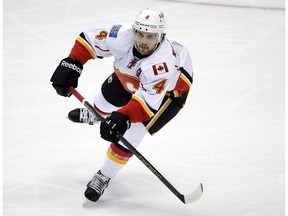 Calgary Flames' Kris Russell moves the puck during the first period of an NHL hockey game against the Anaheim Ducks, in Anaheim, Calif.  On Monday, Feb. 29, 2016.