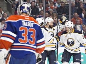 Buffalo Sabres' Matt Moulson (26), Ryan O'Reilly (90) and Kyle Okposo (21) celebrate a goal on Edmonton Oilers goalie Cam Talbot (33) during first period NHL action in Edmonton on Oct. 16, 2016.