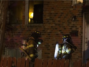 Firefighters enter a home at 11919 94 Street on Sunday, October 23, 2016 in Edmonton.