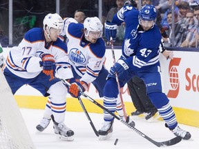 Toronto Maple Leafs' Nazem Kadri, right, fights for the puck with Edmonton Oilers Oscar Klefbom, left, and Anton Lander during second period NHL hockey action in Toronto on Monday, November 30, 2015. Going into the finale of his team's five-game road trip, Edmonton Oilers coach Todd McLellan knew a victory would be a huge confidence boost. He wouldn't have thrown a parade, but it would've represented a big accomplishment.Instead, the Oilers were shut out by the Toronto Maple Leafs to fall to 1-3-1 on the trip.